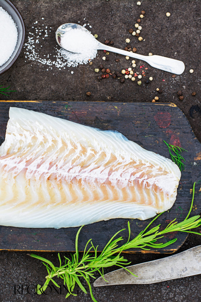 Fresh raw halibut on cutting board