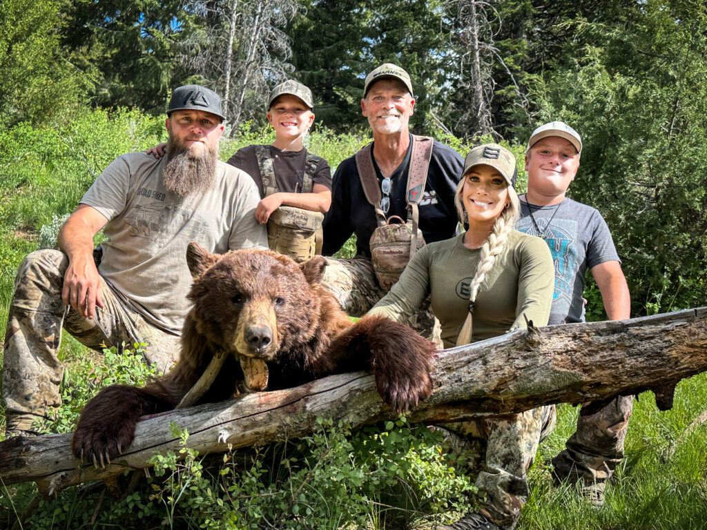 Brittney with her family and her Utah Black Bear in the Mountains
