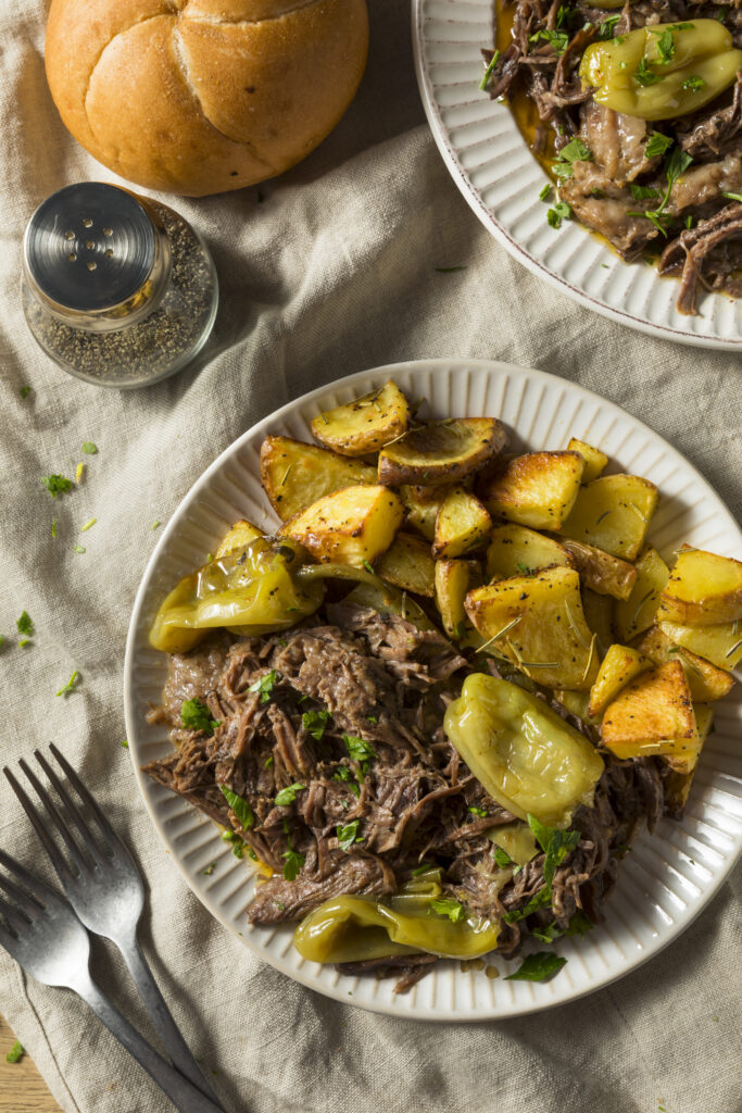 Slow Cooker Venison Mississippi Pot Roast Plated with roasted potatoes